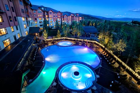 a night time image of the pool at The Steamboat Grand hotel
