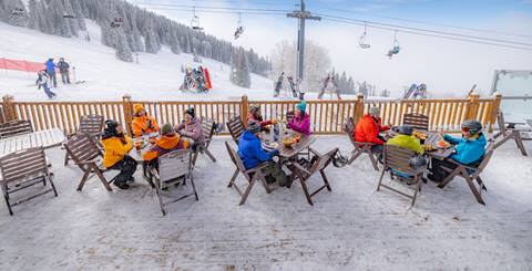 people eating on the outside patio on the mountain
