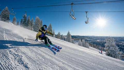 A skier going down a groomed trail at Steamboat Resort.