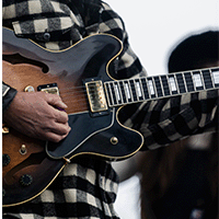 Guitarist playing music.