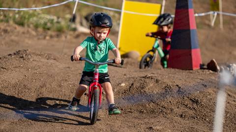 A young boy riding his stridor bike on the stridor course at Steamboat Resort.