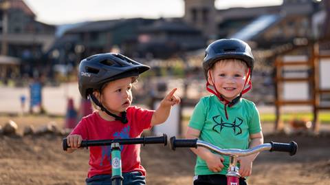 Two young boy riding their stridor bikes on the stridor course at Steamboat Resort.