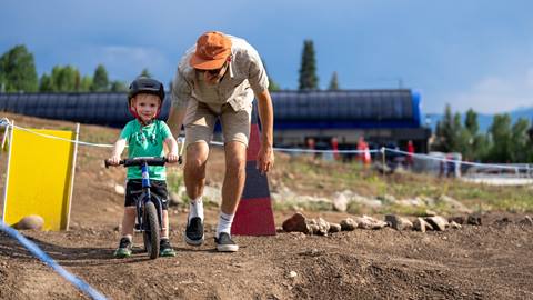 A young boy riding his stridor bike on the stridor course at Steamboat Resort.