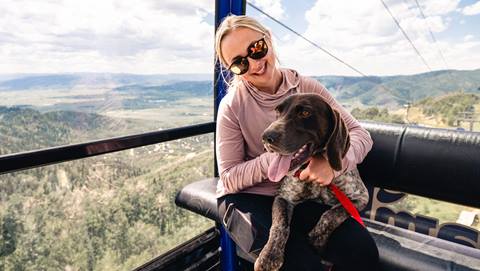 A woman and her dog on the Steamboat Gondola.