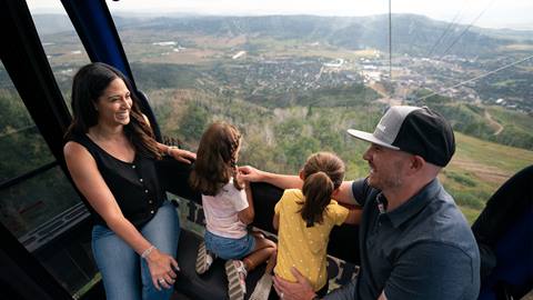 A family of four riding the Steamboat Gondola at Steamboat Resort.