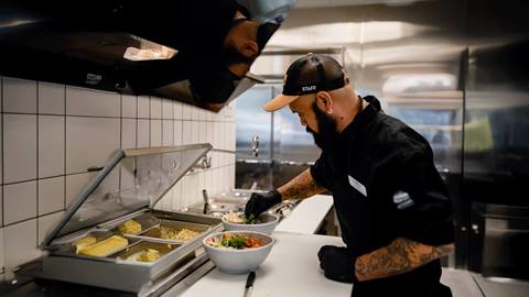 A chef preparing a meal at The Range Food & Drink Hall at Steamboat Resort.