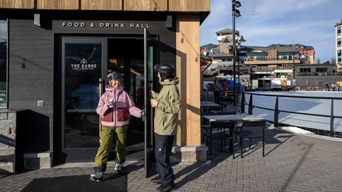 A couple walking out of Cowboy Coffee at Steamboat Resort.