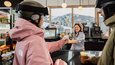 A couple buying coffee at Cowboy Coffee at Steamboat Resort.