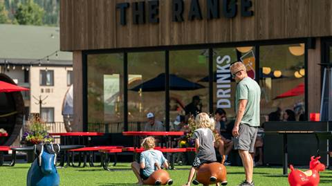 Kids riding bouncy balls outside The Range Food & Drink Hall