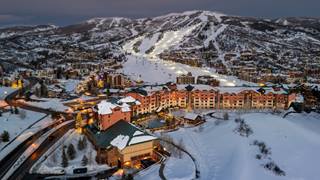 The Steamboat Grand hotel aerial image with night skiing in the back at Steamboat Resort.