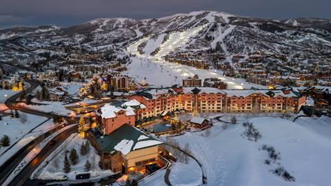The Steamboat Grand hotel aerial image with night skiing in the back at Steamboat Resort.